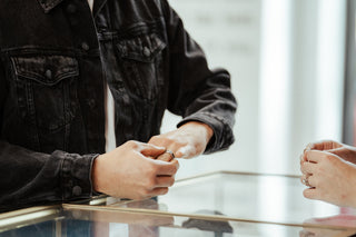 A man tries on a tri-coloured wedding band for him at Perrara in Kelowna.