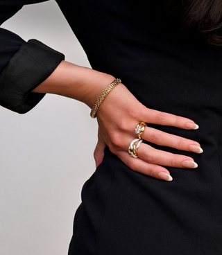 Everyday statement rings in gold and diamond, styled on hand, from Perrara in Kelowna