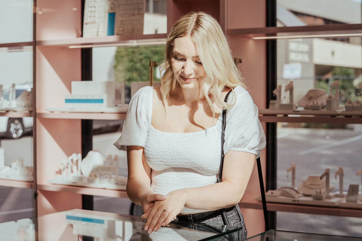 A client looking into the engagement ring case at Perrara in Kelowna