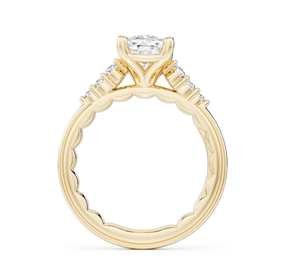 A yellow gold engagement ring setting seen in profile, with its matching band
