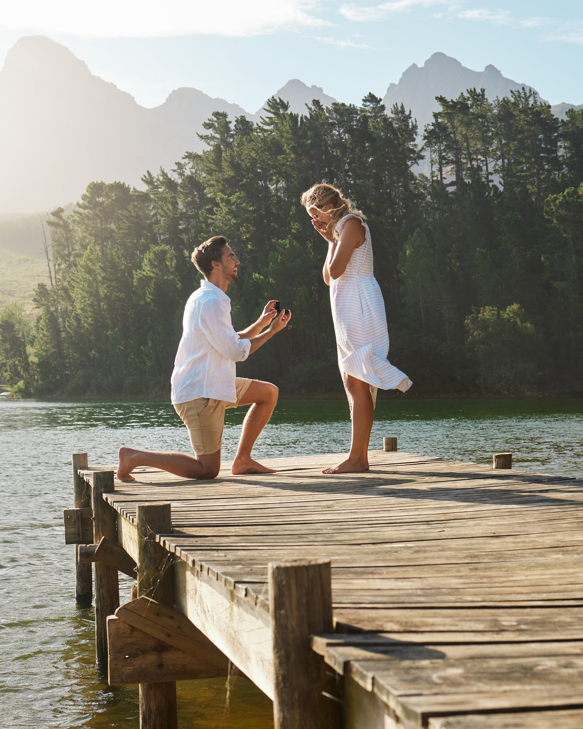 A proposal on a lakeside dock at sunset