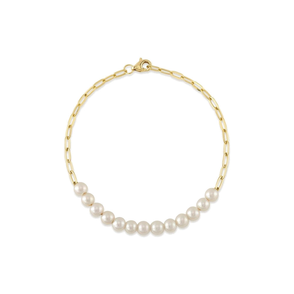 A gold paperclip bracelet with pearls