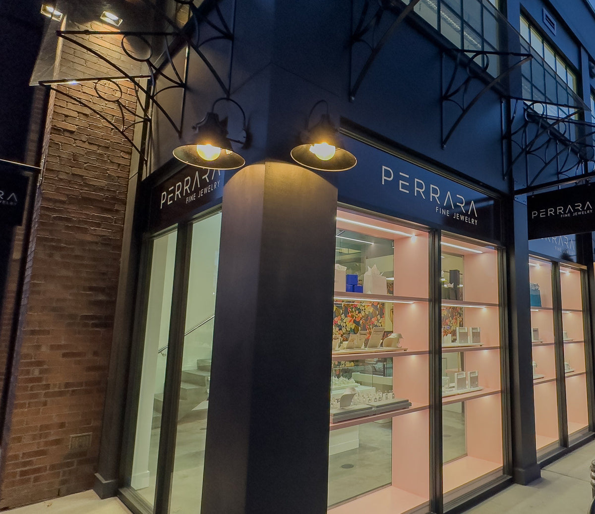 The Perrara Fine Jewelry storefront on KLO Road in Kelowna, lit in the evening