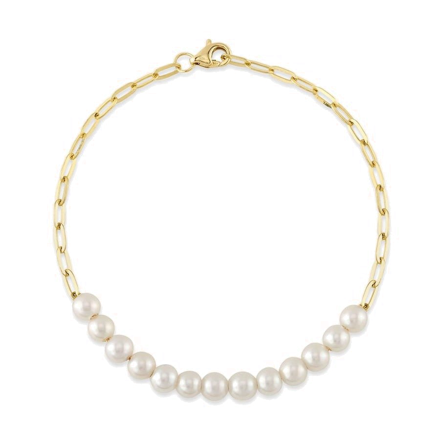 A gold paperclip bracelet with pearls